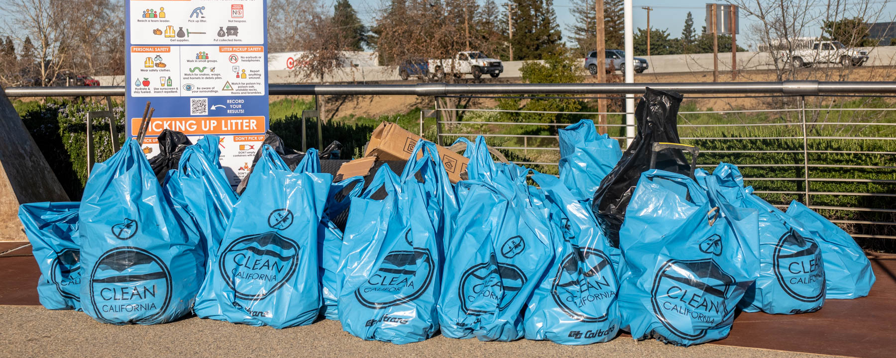 This is an image of filled blue garbage bags from a Clean California Program event. 